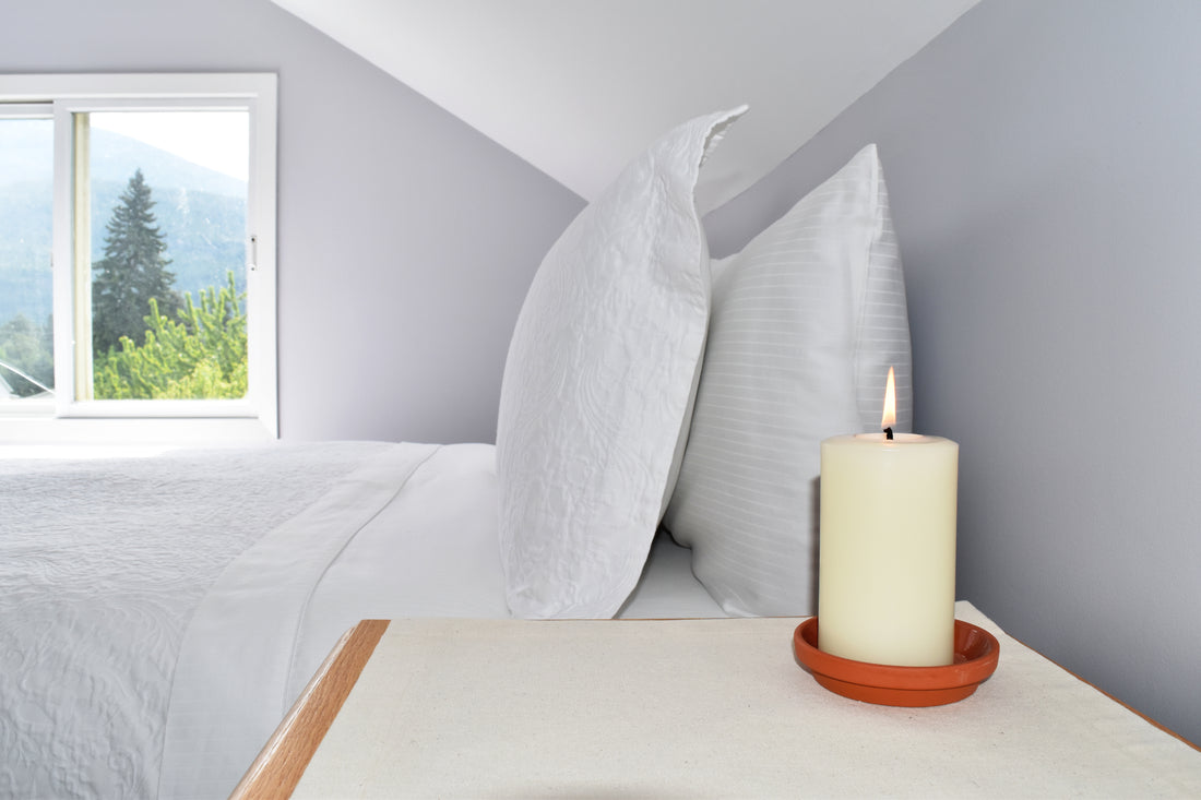 elegant white pure beeswax pillar candle in a bedroom